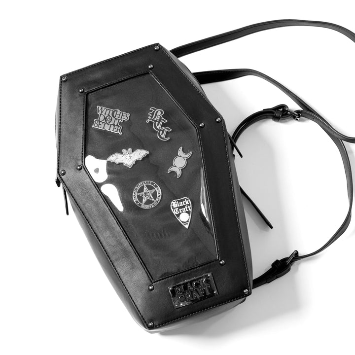 Black faux leather coffin shaped backpack with a Pin Collecting Window. 