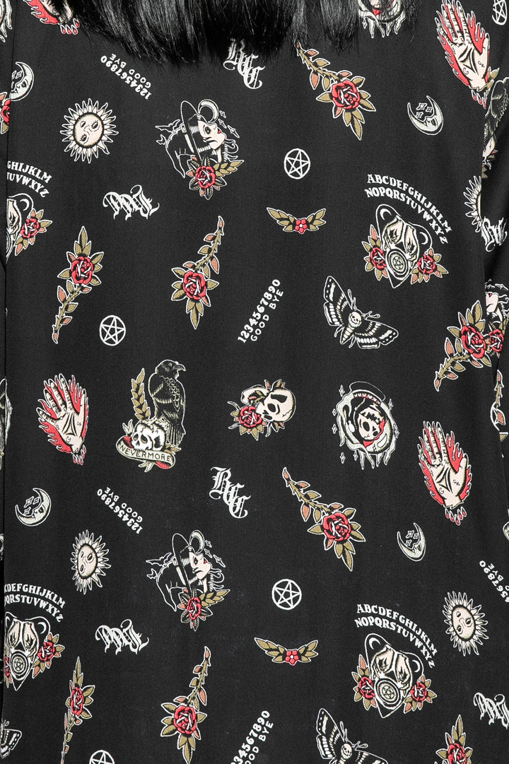A gothic kimono cover up with fringed trim, and open front, and kimono half length sleeves.