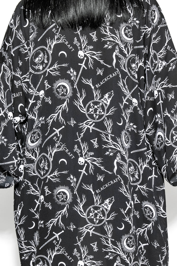 A gothic duster kimono cover up with an open front and long sleeves.