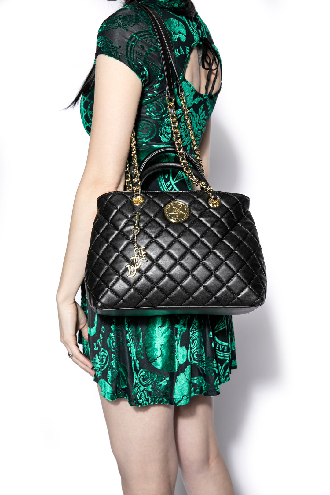 Black quilted satchel with magnetic closure. 