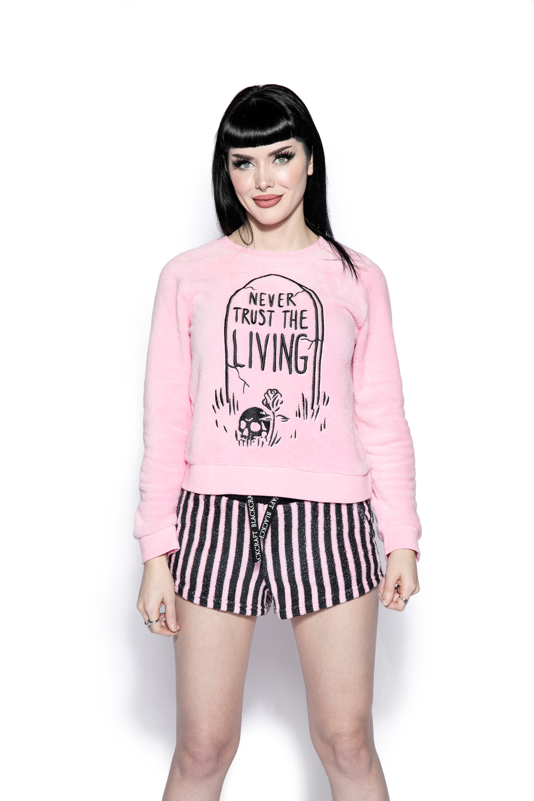 A pink and black soft fleece gothic pajama set featuring a long sleeve pullover top and micro shorts, from Blackcraft.