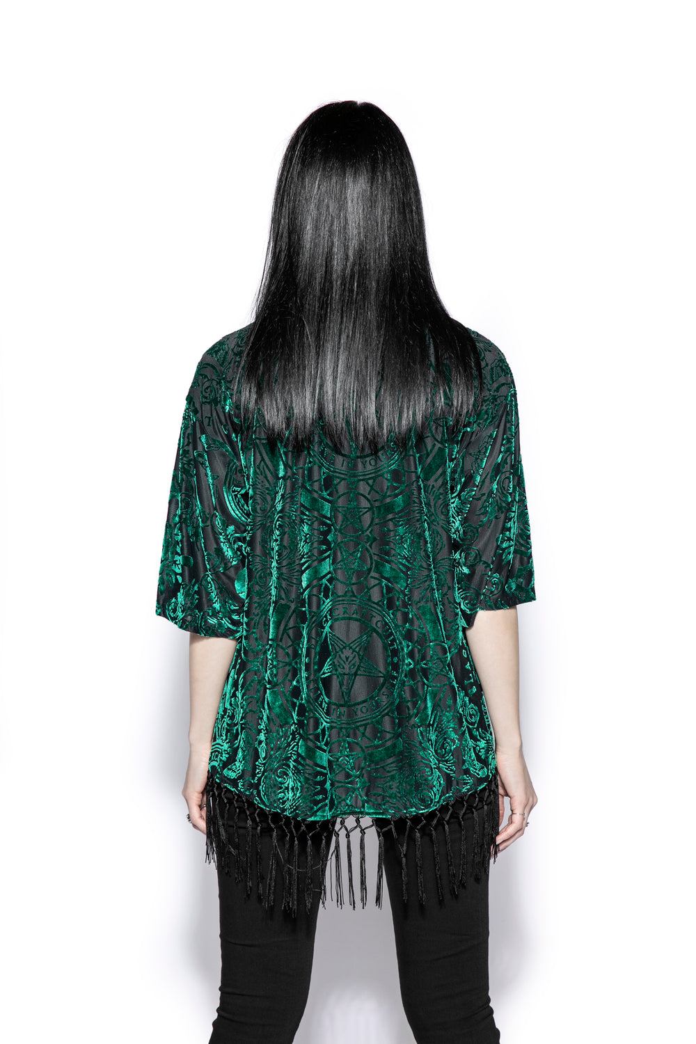 A gothic velvet kimono cover up with fringed trim, an open front, and kimono half length sleeves.