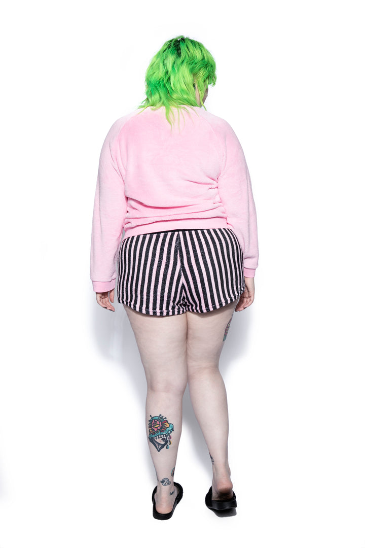 A pink and black soft fleece gothic pajama set featuring a long sleeve pullover top and micro shorts, from Blackcraft.