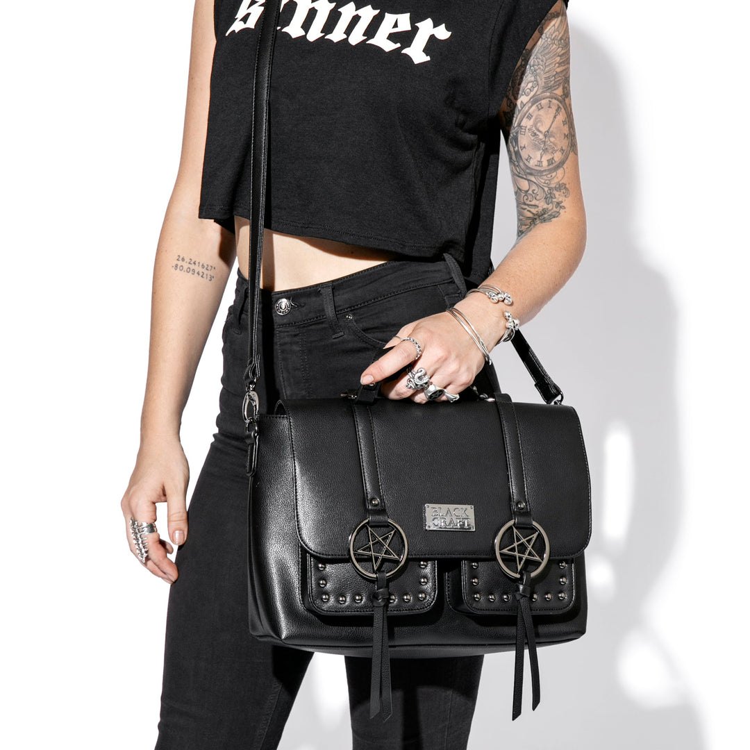 Black faux leather messenger bag with gunmetal finish pentagrams and Blackcraft logo plaque. 
