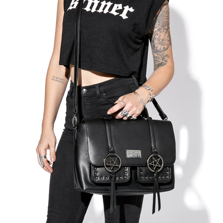 Black faux leather messenger bag with gunmetal finish pentagrams and Blackcraft logo plaque. 