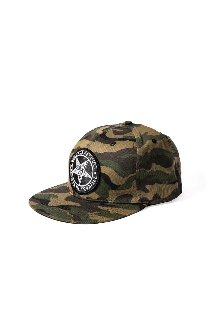 A cotton snapback hat in a camo design, with an embroidered Blackcraft patch on the front.