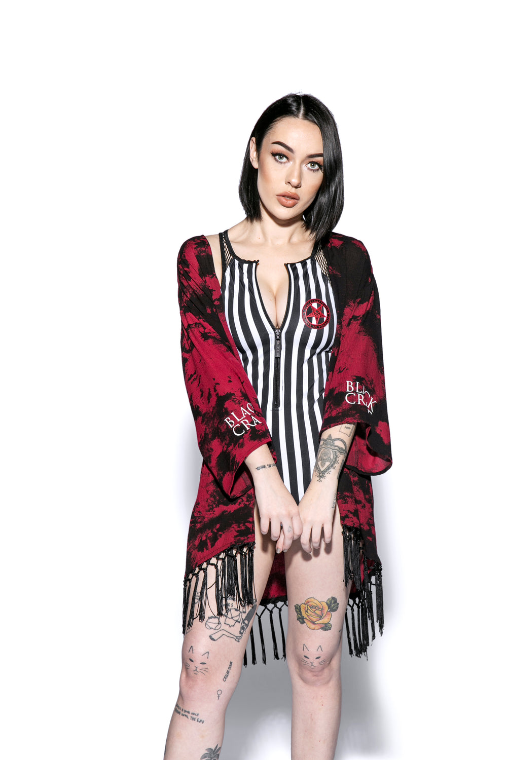 A gothic kimono cover up with fringed trim, and open front, and kimono half length sleeves.