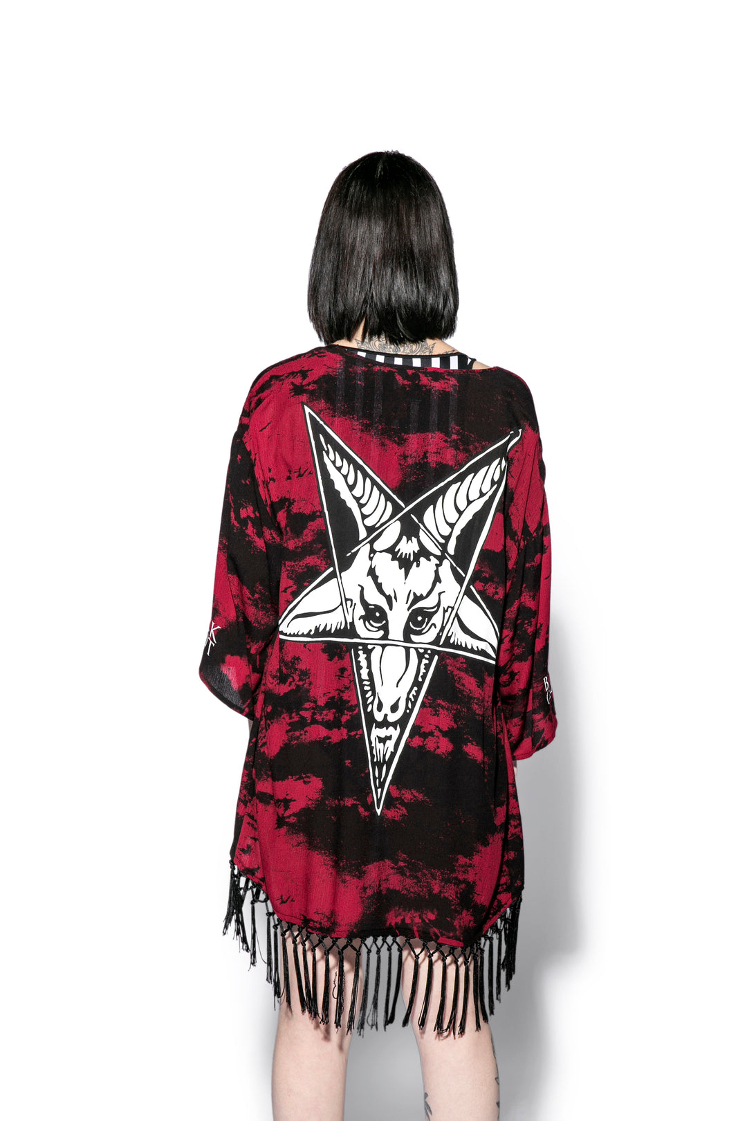 A gothic kimono cover up with fringed trim, and open front, and kimono half length sleeves.