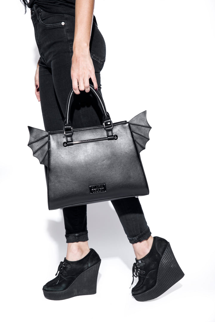 Black faux leather bat wing satchel. 