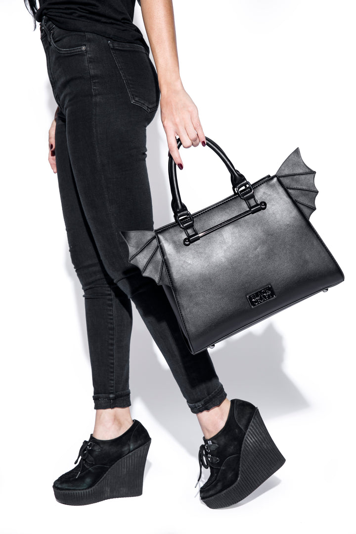 Black faux leather bat wing satchel. 