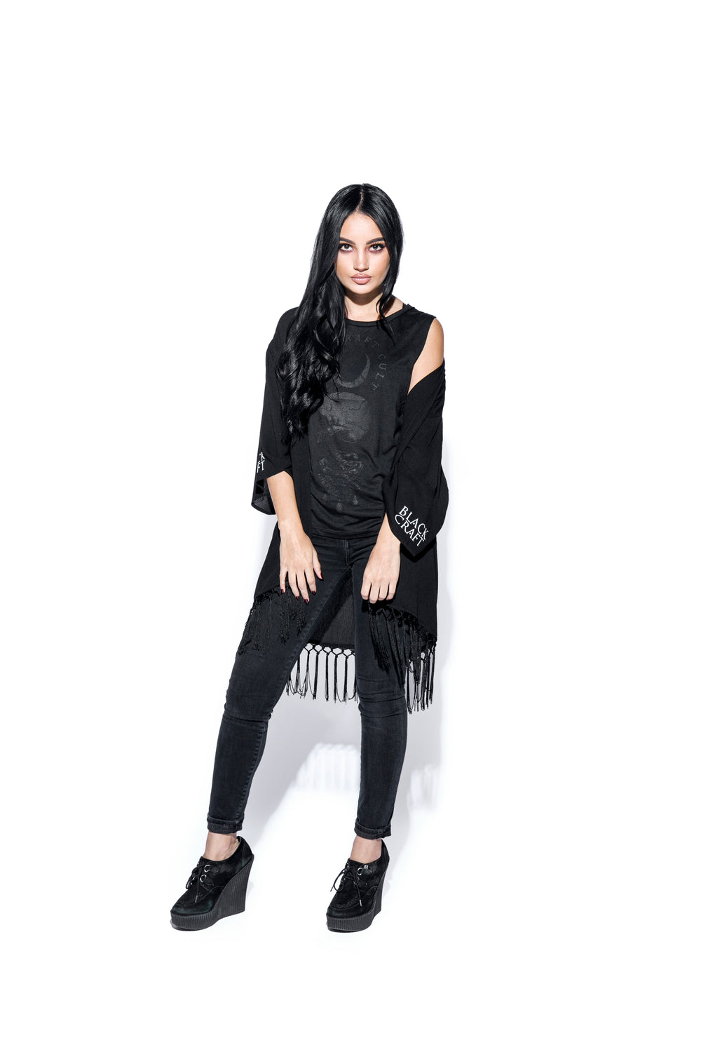 A gothic kimono cover up with fringed trim, and open front, and kimono half length sleeves.