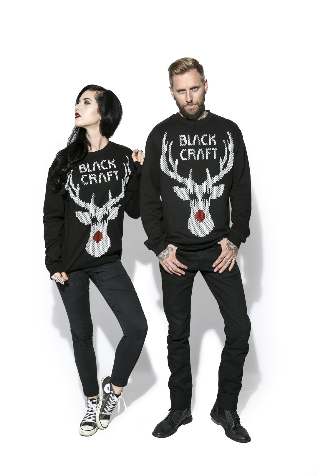 Two models wearing a black sweatshirt with the Blackcraft logo and a reindeer on the front and text on the back. 