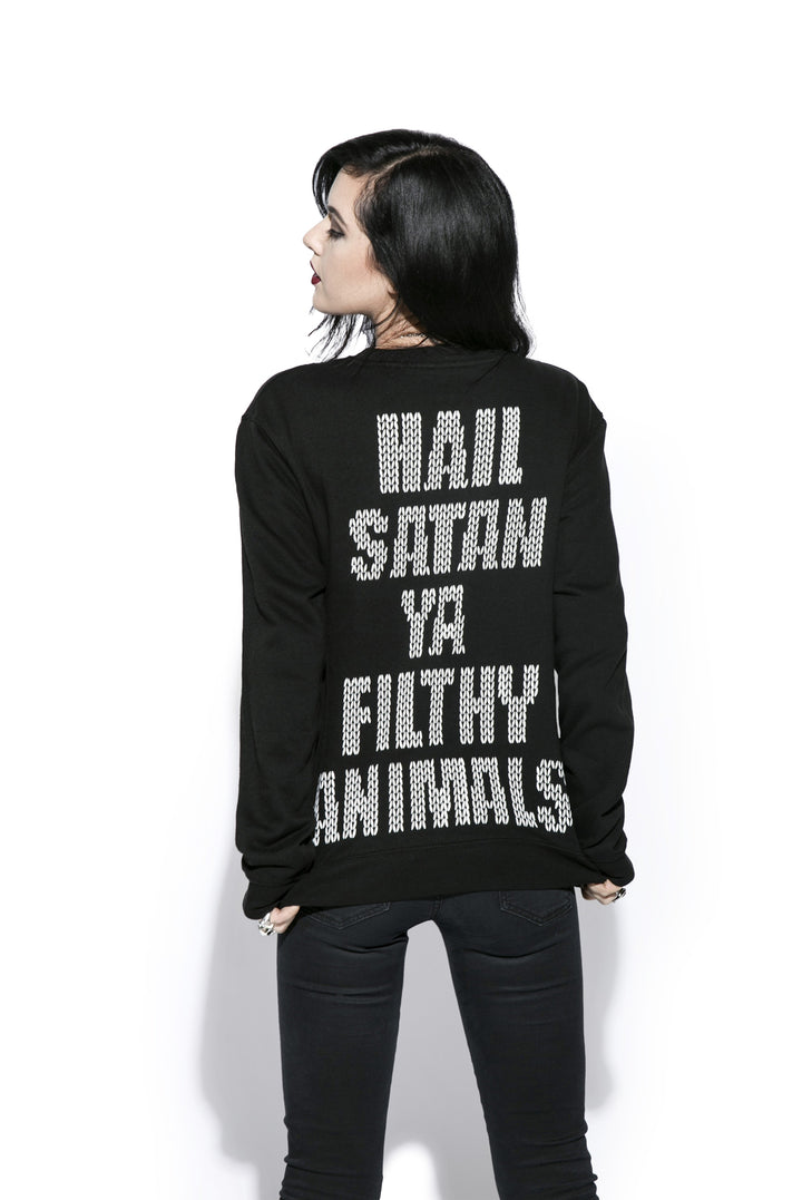 A black haired model wearing a black sweatshirt with the Blackcraft logo and a reindeer on the front and text on the back. 
