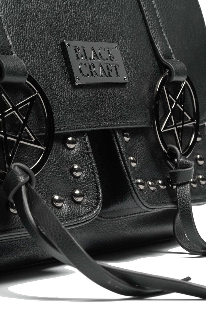 Black faux leather messenger bag with gunmetal finish pentagrams and Blackcraft logo plaque. 
