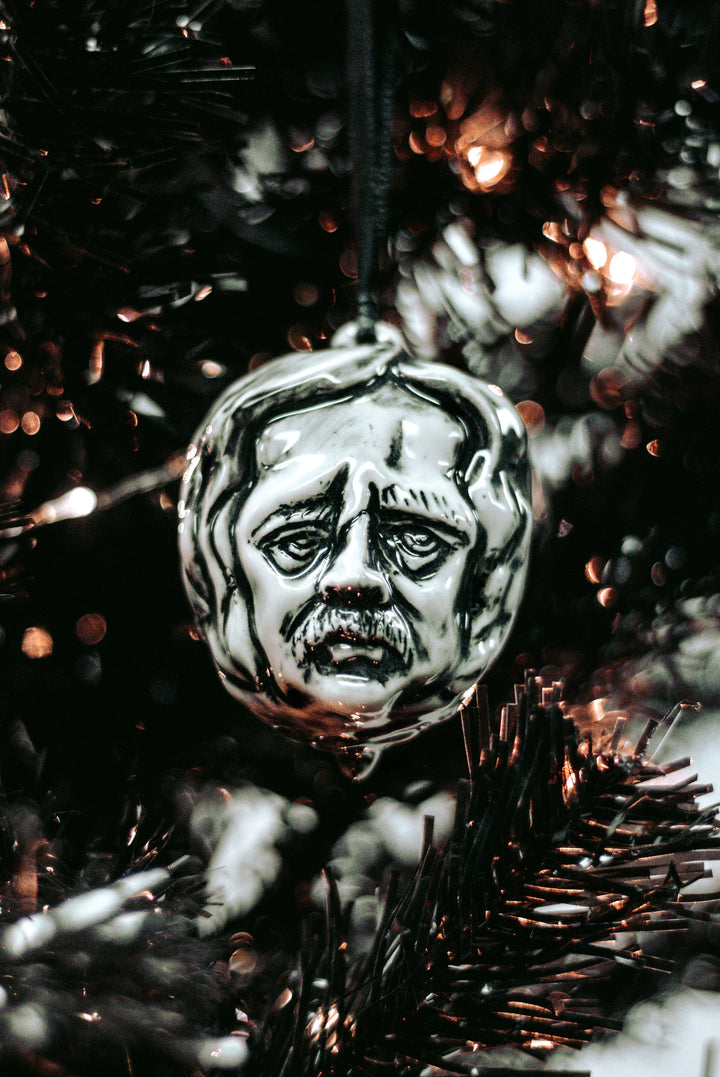 A ceramic Christmas tree ornament in the shape of Edgar Allen Poe's head, from Blackcraft.
