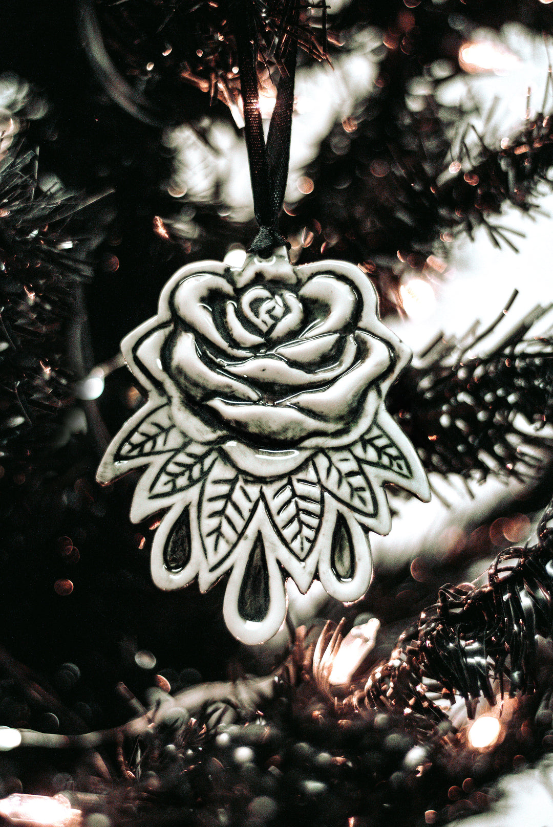 A three piece ceramic Christmas tree ornament set with skull, moon, and rose ornaments. From Blackcraft.