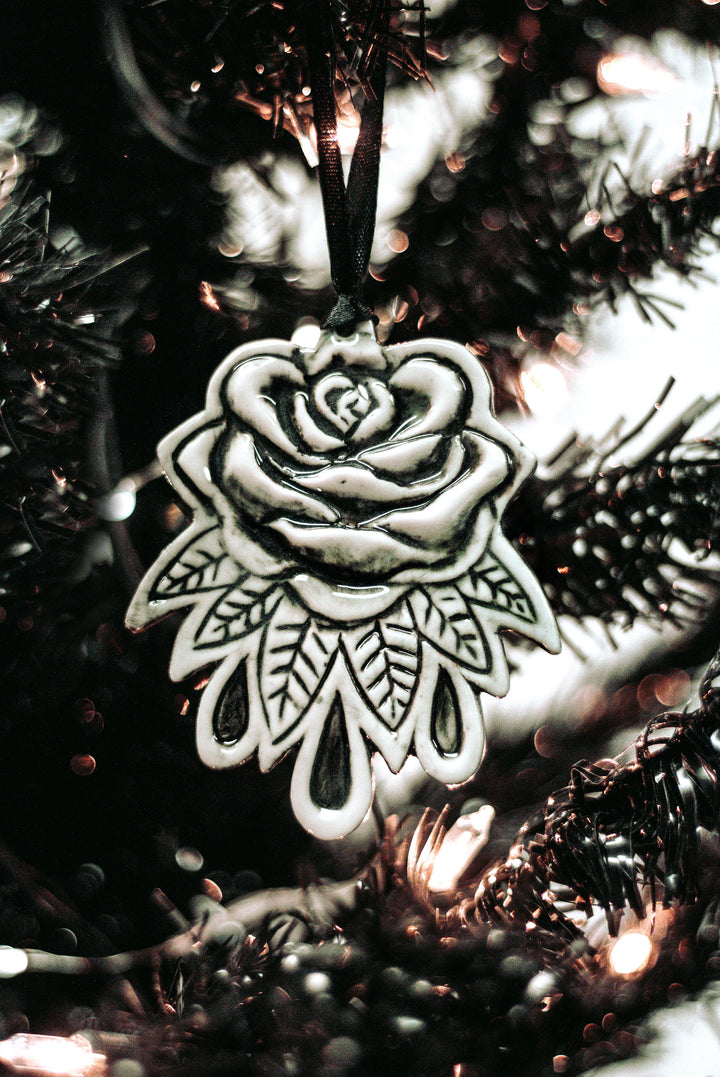 A three piece ceramic Christmas tree ornament set with skull, moon, and rose ornaments. From Blackcraft.