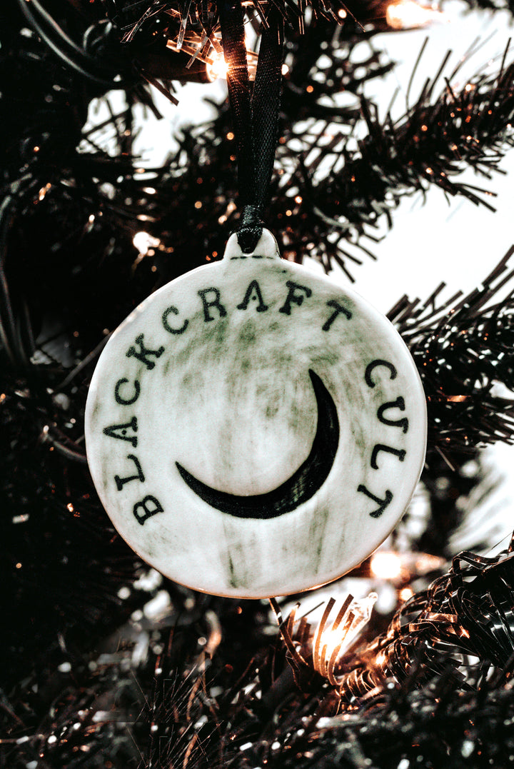 A three piece ceramic Christmas tree ornament set with skull, moon, and rose ornaments. From Blackcraft.