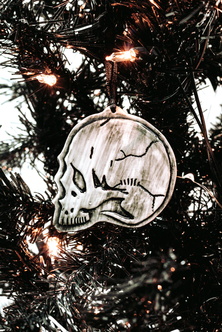 A three piece ceramic Christmas tree ornament set with skull, moon, and rose ornaments. From Blackcraft.