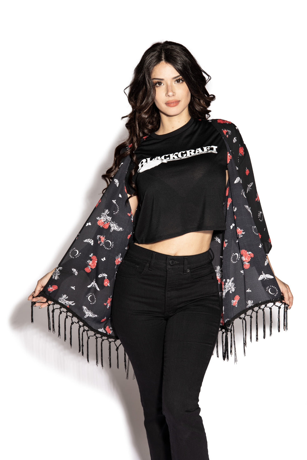 A gothic kimono cover up with fringed trim, and open front, and kimono half length sleeves.