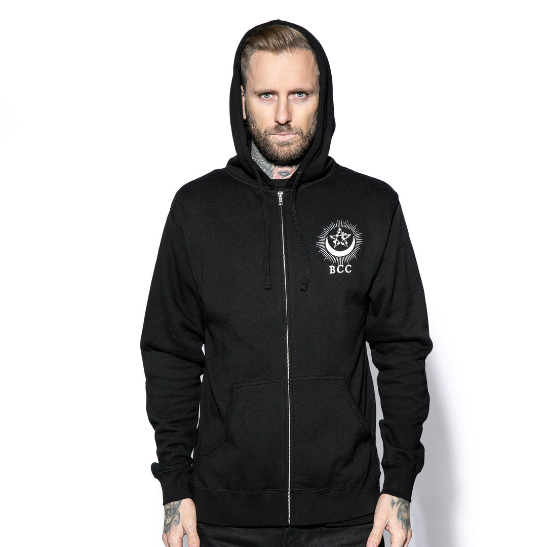 A male model wearing a classic black zip up hoodie with custom Blackcraft artwork on the front and back. 
