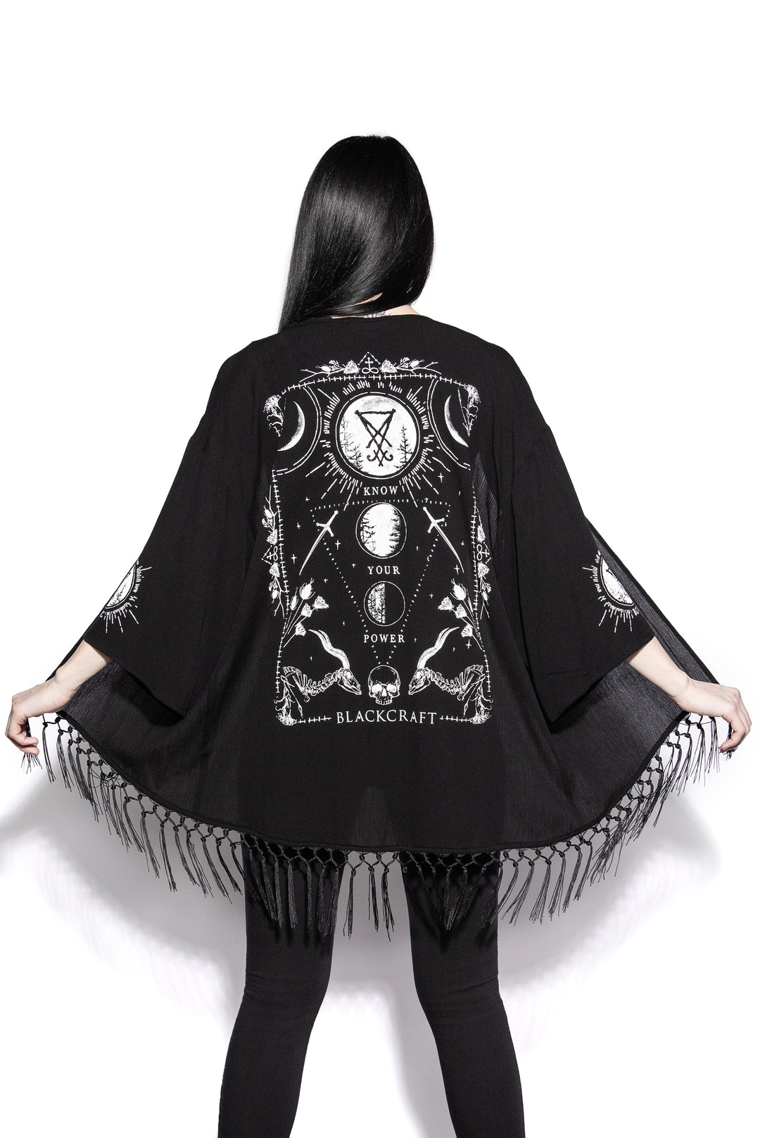 A gothic kimono cover up with fringed trim, and open front, and kimono half length sleeves.