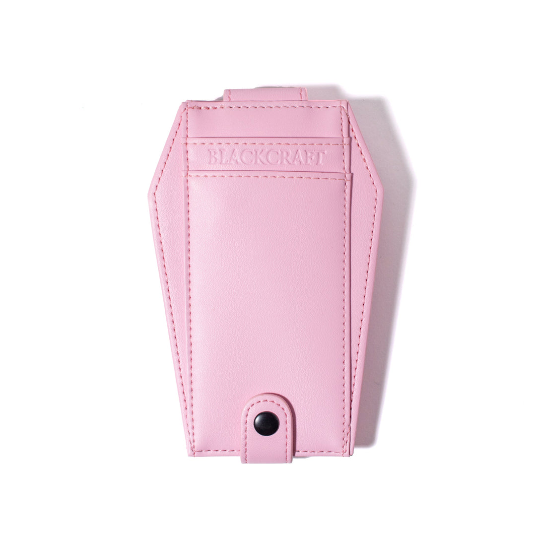 Pink faux leather cardholder in coffin shape.
