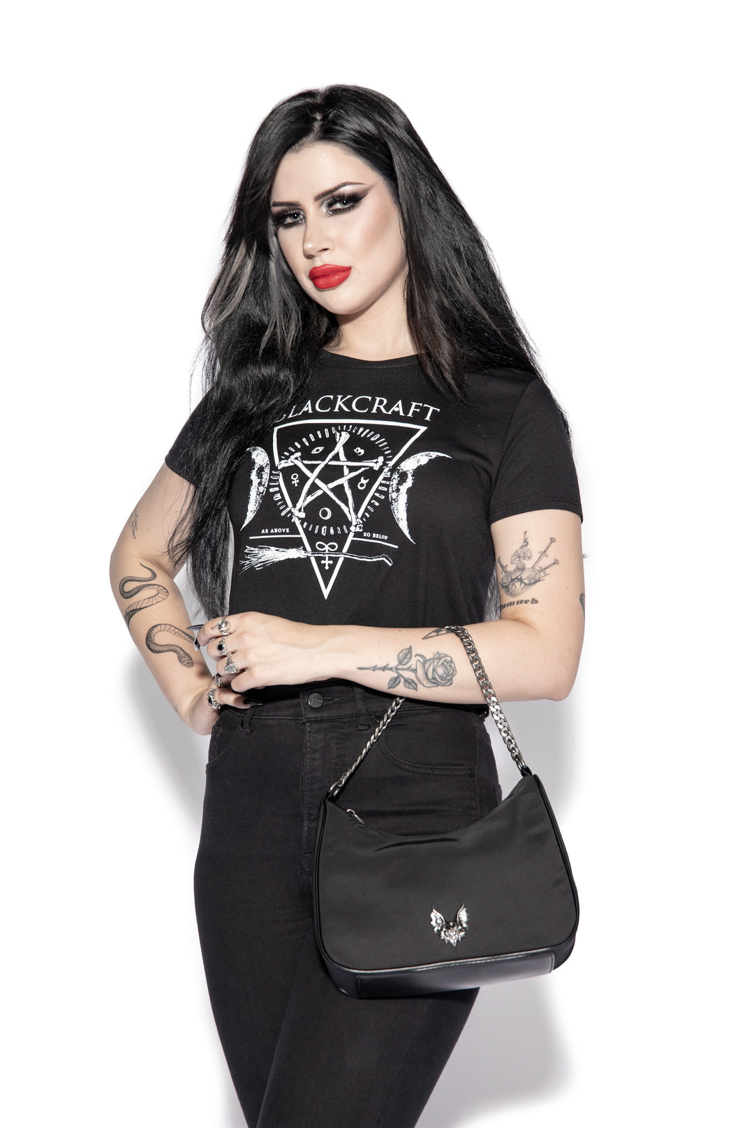 Black nylon crossbody bag with chain top handle and removable coin purse attachment.