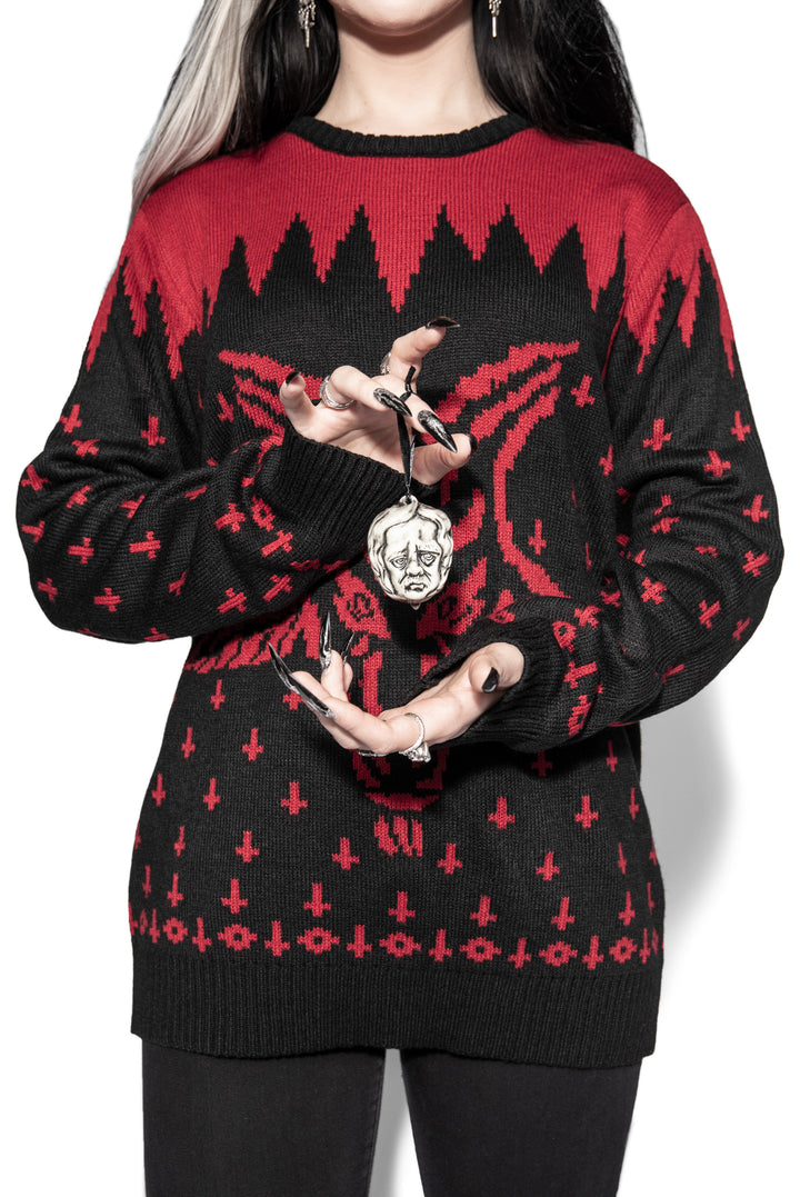 A model holding a ceramic Christmas tree ornament in the shape of Edgar Allen Poe's head, from Blackcraft.