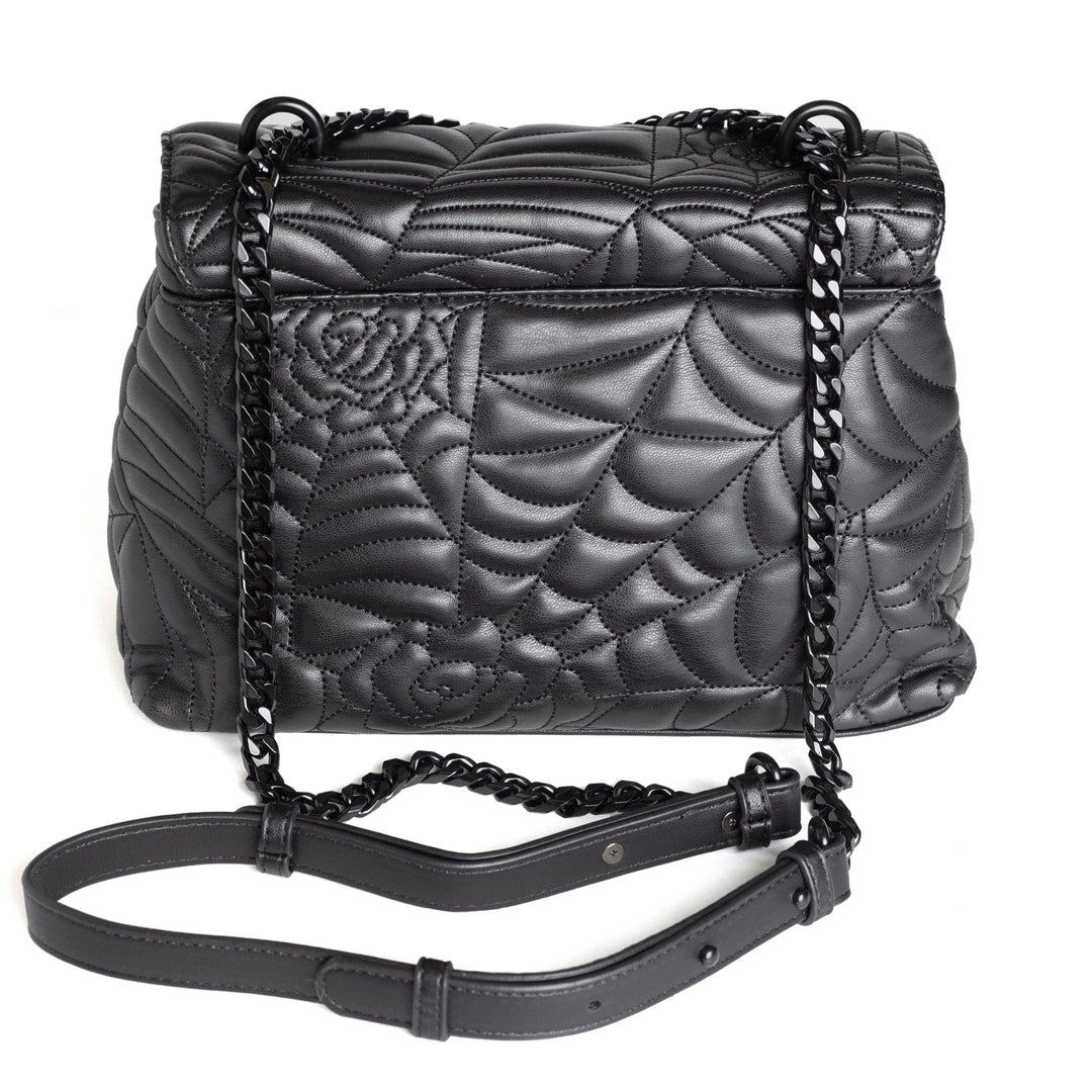 Black spider web inspired shoulder bag with adjustable strap. 