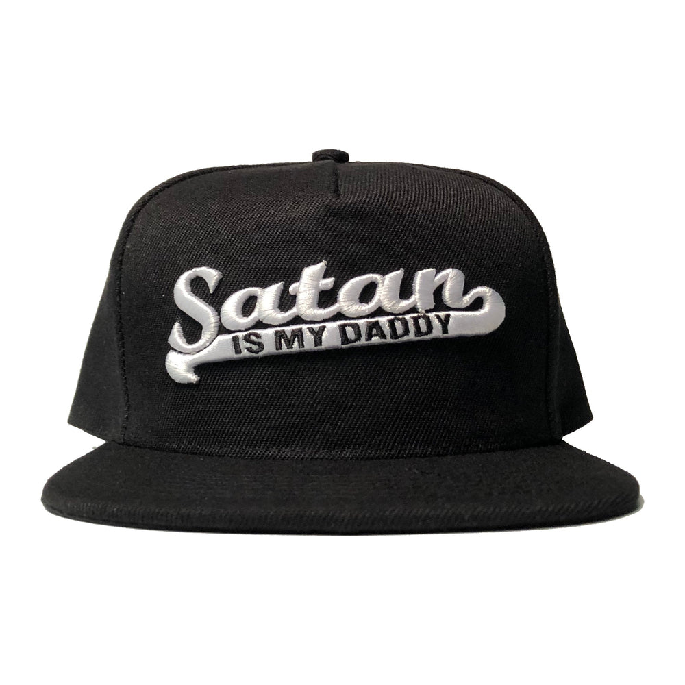 A black snapback hat with white embroidered Satan is my Daddy on the front. 