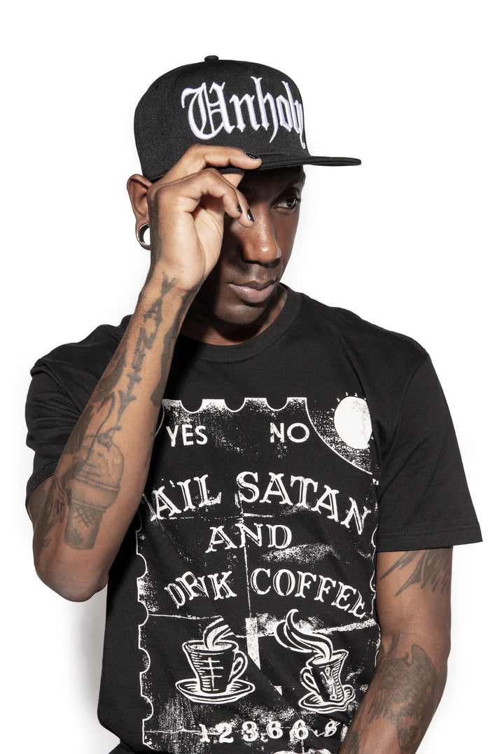 A classic black baseball cap with Unholy embroidered across the front.